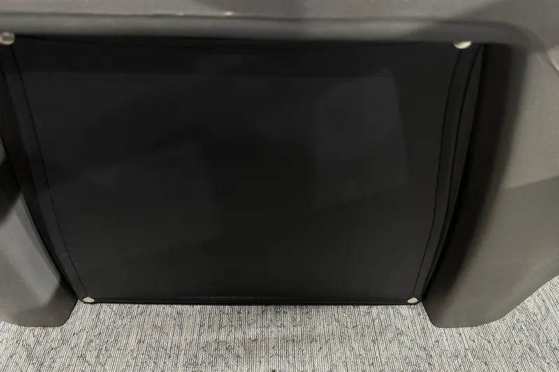 Slide: The Image of 2026 Sun Tracker Bass Buggy 18 DLX interior detail with black panel and gray flooring. - 36