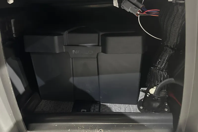 Slide: The Image of Battery compartment of 2026 Sun Tracker Bass Buggy 18 DLX with wiring and connections. - 37