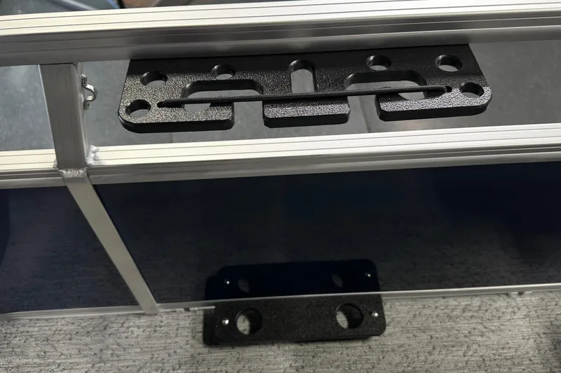 Slide: The Image of 2026 Sun Tracker Bass Buggy 18 DLX boat detail with metal bracket and frame. - 42