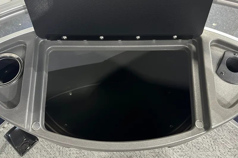 Slide: The Image of 2026 Sun Tracker Bass Buggy 18 DLX storage compartment with cup holders and sleek design. - 45