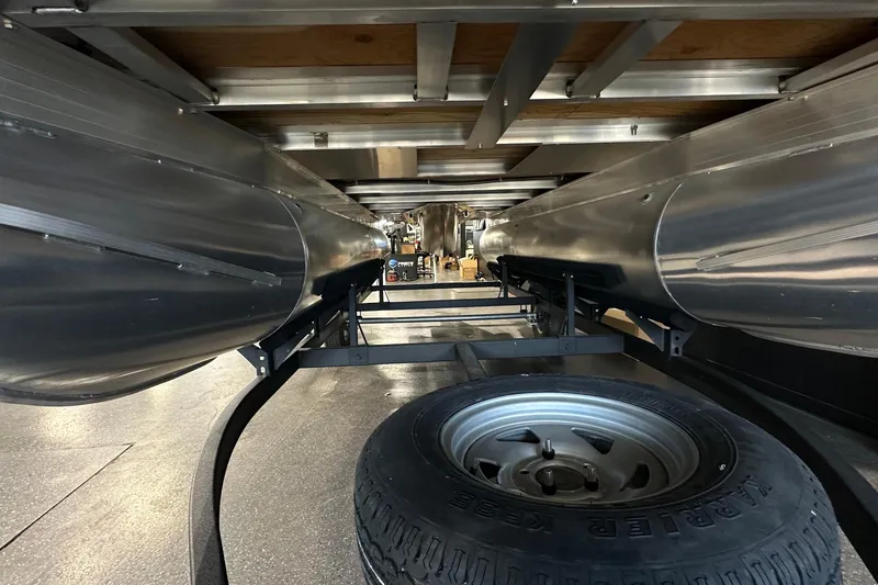 Slide: The Image of Underneath view of 2026 Sun Tracker Bass Buggy 18 DLX pontoon boat with spare tire. - 49