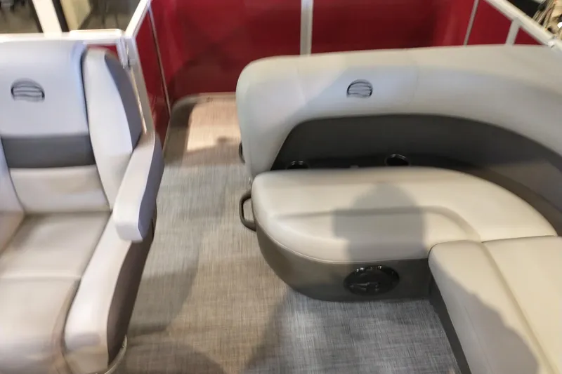 Slide: The Image of 2026 Sun Tracker Party Barge 18 DLX interior with gray seating and red paneling. - 5