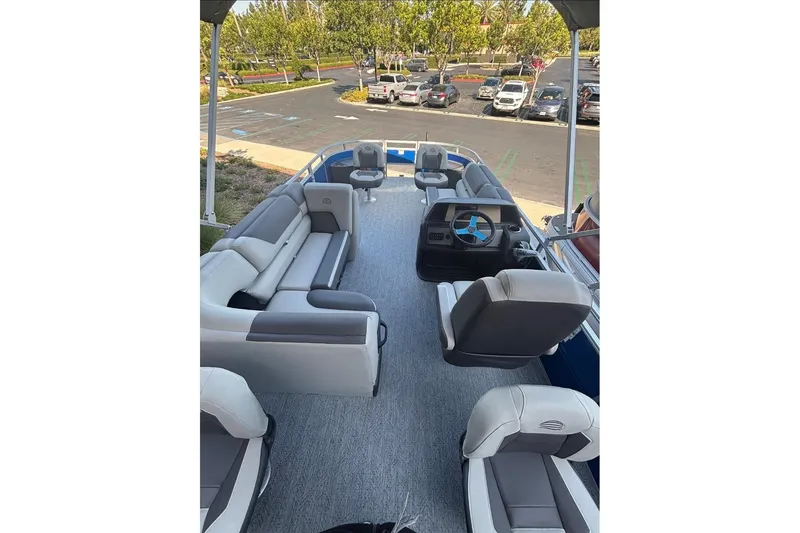 Slide: The Image of 2026 Sun Tracker Fishin' Barge 20 DLX interior with seating and steering console. - 3