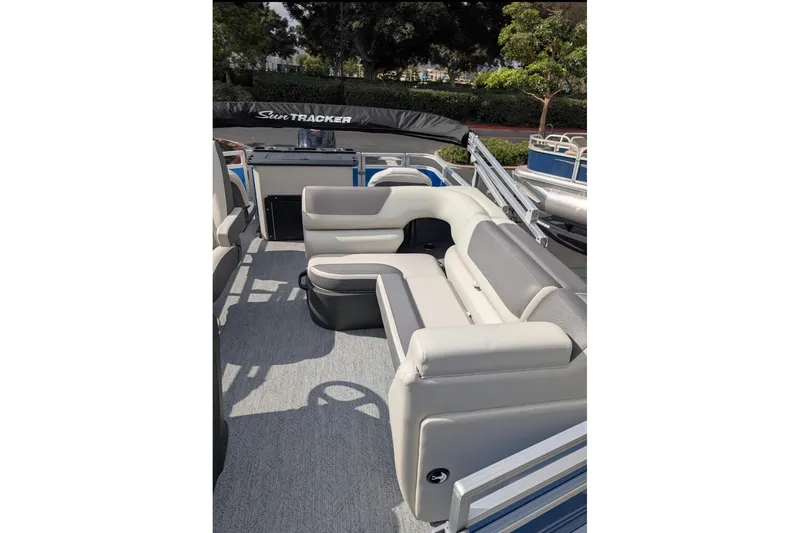 Slide: The Image of 2026 Sun Tracker Fishin' Barge 20 DLX interior with comfortable seating and modern design. - 4