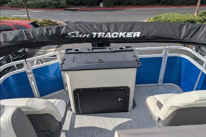 Slide: The Image of 2026 Sun Tracker Fishin' Barge 20 DLX interior with seating and storage. - 5