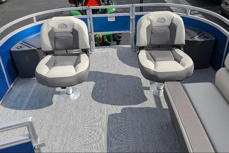 Slide: The Image of 2026 Sun Tracker Fishin' Barge 20 DLX interior with two swivel seats and carpeted flooring. - 6