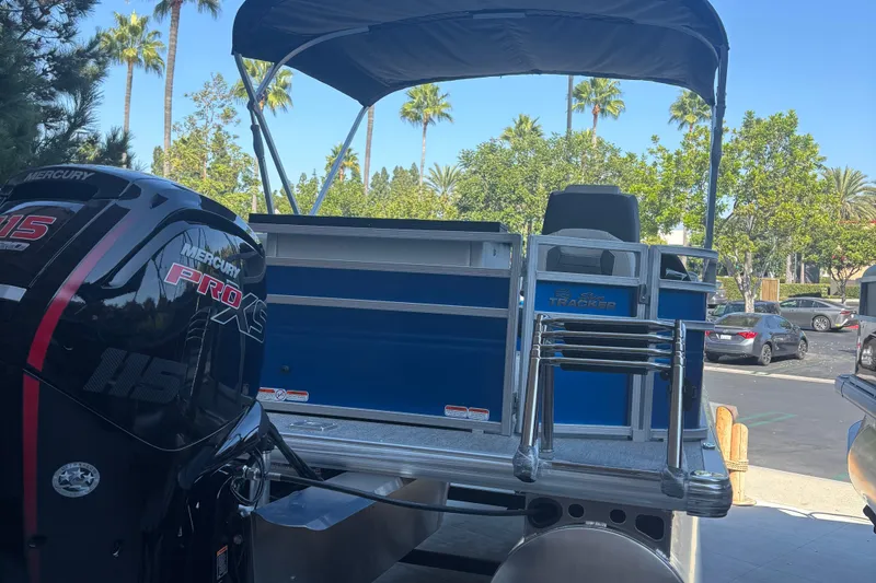 Slide: The Image of 2026 Sun Tracker Fishin' Barge 20 DLX with Mercury Pro XS engine in a sunny parking lot. - 7