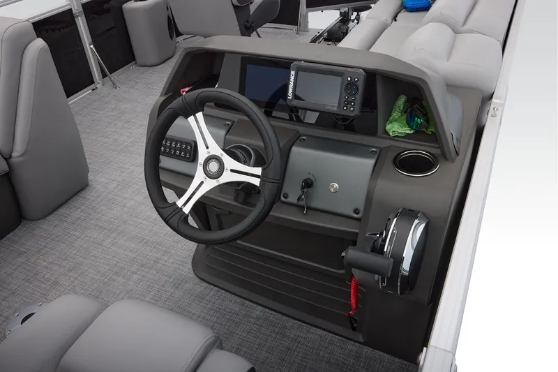 Slide: The Image of 2026 Sun Tracker SportFish 20 DLX storage compartment with safety lanyard on textured flooring. - 42