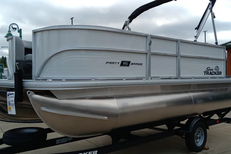 Slide: The Image of 2026 Sun Tracker Party Barge 16 DLX pontoon boat on trailer, side view. - 47