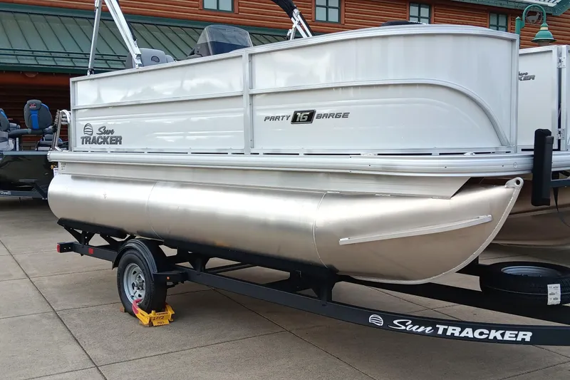 Slide: The Image of 2026 Sun Tracker Party Barge 16 DLX pontoon boat on trailer, side view. - 48