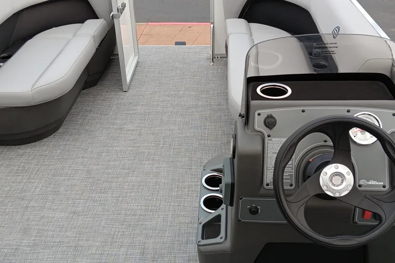 Slide: The Image of 2026 Sun Tracker Party Barge 16 DLX interior with steering console and seating. - 50