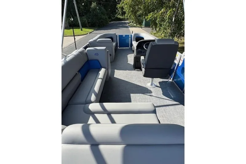 Slide: The Image of 2026 Sun Tracker Party Barge 20 DLX interior with spacious seating and helm. - 11
