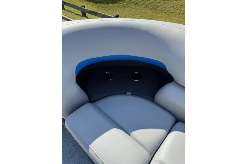Slide: The Image of 2026 Sun Tracker Party Barge 20 DLX boat seating with cup holders, featuring gray upholstery. - 12