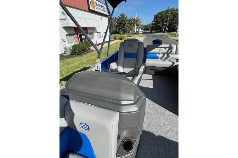 Slide: The Image of 2026 Sun Tracker Party Barge 20 DLX interior with gray and blue seating. - 13