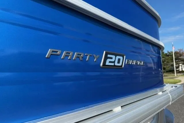 Slide: The Image of 2026 Sun Tracker Party Barge 20 DLX, blue exterior, close-up view. - 5
