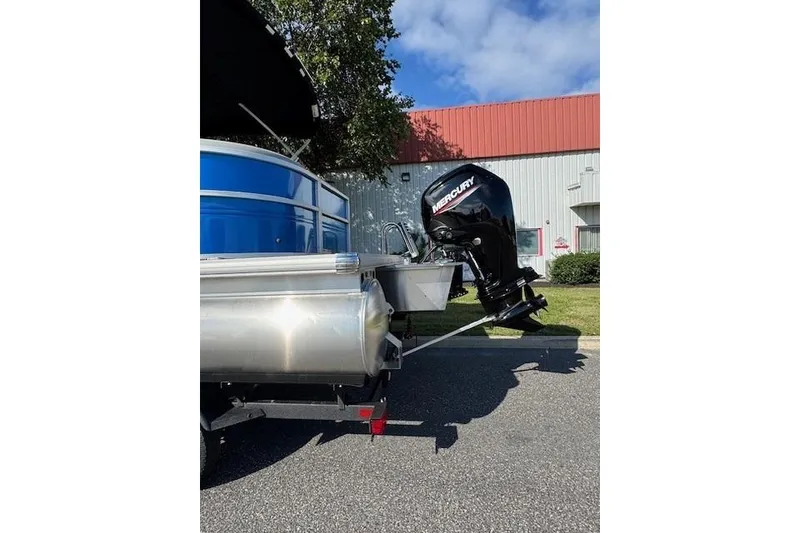 Slide: The Image of 2026 Sun Tracker Party Barge 20 DLX with Mercury outboard motor in parking lot. - 7