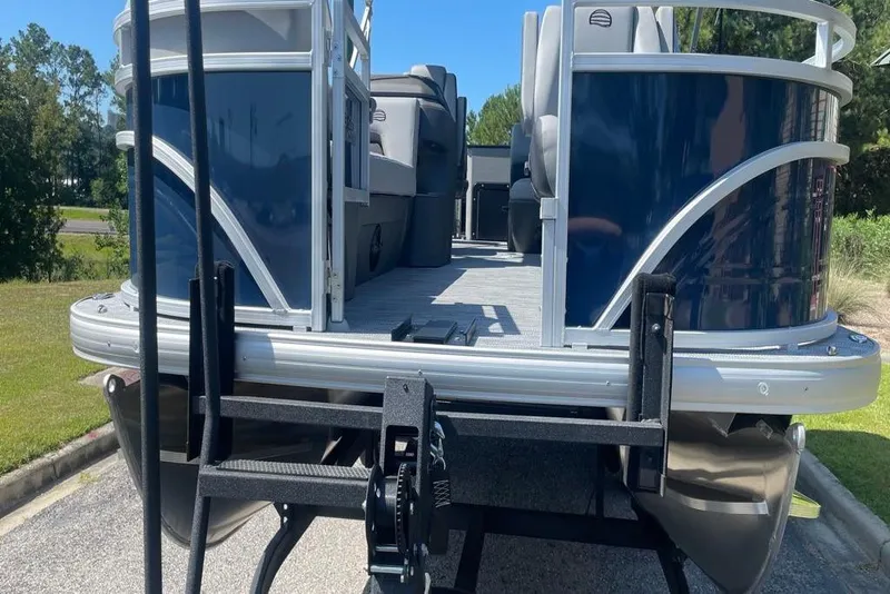 Slide: The Image of 2026 Sun Tracker SportFish 20 DLX pontoon boat on trailer, rear view. - 4