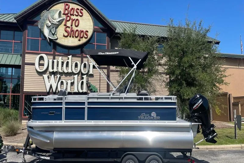 Slide: The Image of 2026 Sun Tracker SportFish 20 DLX pontoon boat outside Bass Pro Shops Outdoor World. - 5