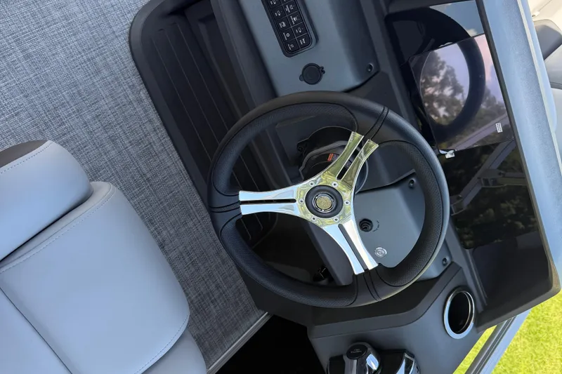 Slide: The Image of 2026 Sun Tracker SportFish 20 DLX steering wheel and dashboard, featuring modern controls. - 73