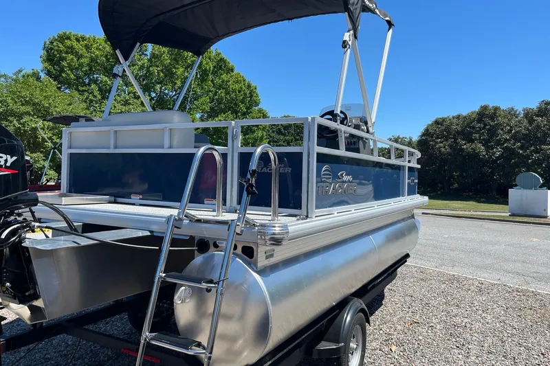 Slide: The Image of 2026 Sun Tracker Bass Buggy 16 XL Select pontoon boat with canopy and ladder. - 2