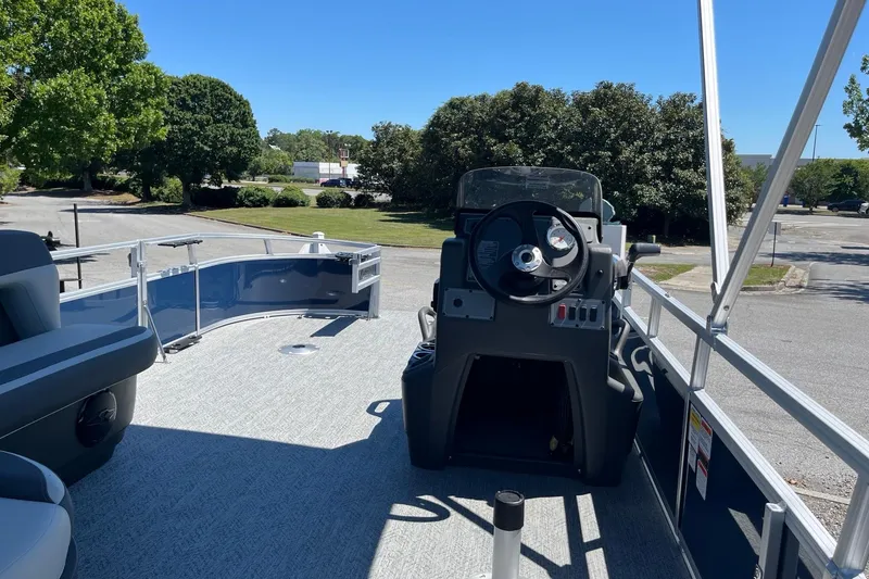 Slide: The Image of 2026 Sun Tracker Bass Buggy 16 XL Select pontoon boat interior with steering console. - 5