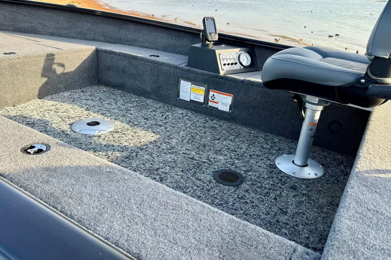 Slide: The Image of Interior of 2026 Tracker Super Guide V-16 T boat with seating and control panel. - 13