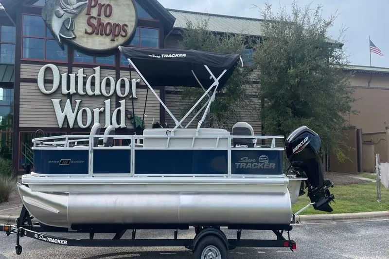 Slide: The Image of 2026 Sun Tracker Bass Buggy 18 DLX pontoon boat outside Pro Shops Outdoor World. - 5