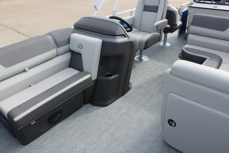 Slide: The Image of 2026 Sun Tracker Fishin' Barge 20 DLX interior with gray seating and steering console. - 9