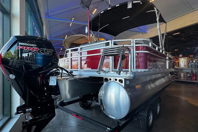 Slide: The Image of 2026 Sun Tracker SportFish 20 DLX pontoon boat displayed indoors. - 3