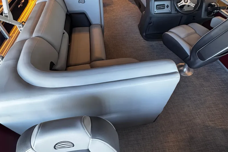 Slide: The Image of 2026 Sun Tracker SportFish 20 DLX pontoon boat with red exterior in showroom. - 5