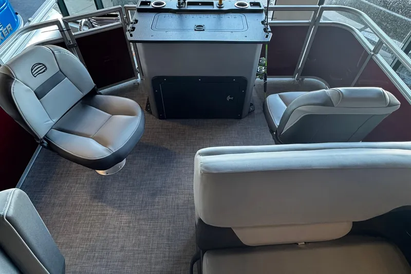 Slide: The Image of 2026 Sun Tracker SportFish 20 DLX pontoon boat with Mercury Pro XS engine displayed indoors. - 6