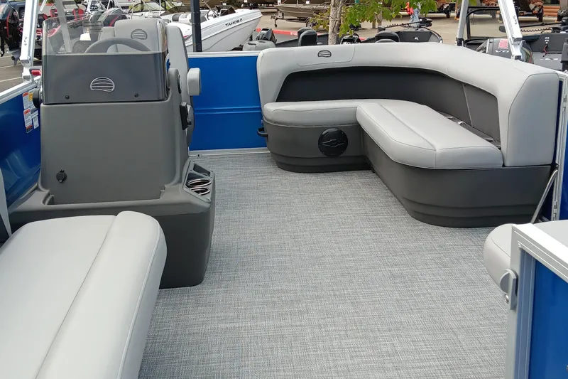 Slide: The Image of 2026 Sun Tracker Party Barge 16 DLX interior with gray seating and blue accents. - 2