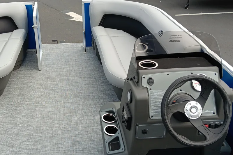 Slide: The Image of 2026 Sun Tracker Party Barge 16 DLX interior with steering console and seating. - 3