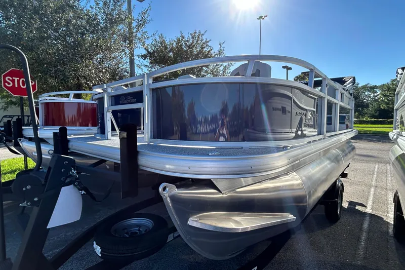 The Image of 2026 Sun Tracker Bass Buggy 16 XL Select pontoon boat in a sunny outdoor setting. - 0