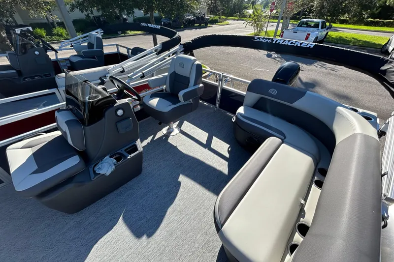 Slide: The Image of 2026 Sun Tracker Bass Buggy 16 XL Select pontoon boat interior with seating and steering console. - 3
