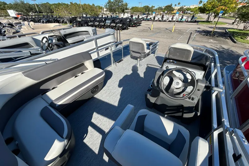 Slide: The Image of 2026 Sun Tracker Bass Buggy 16 XL Select pontoon boat interior with seating and steering console. - 4