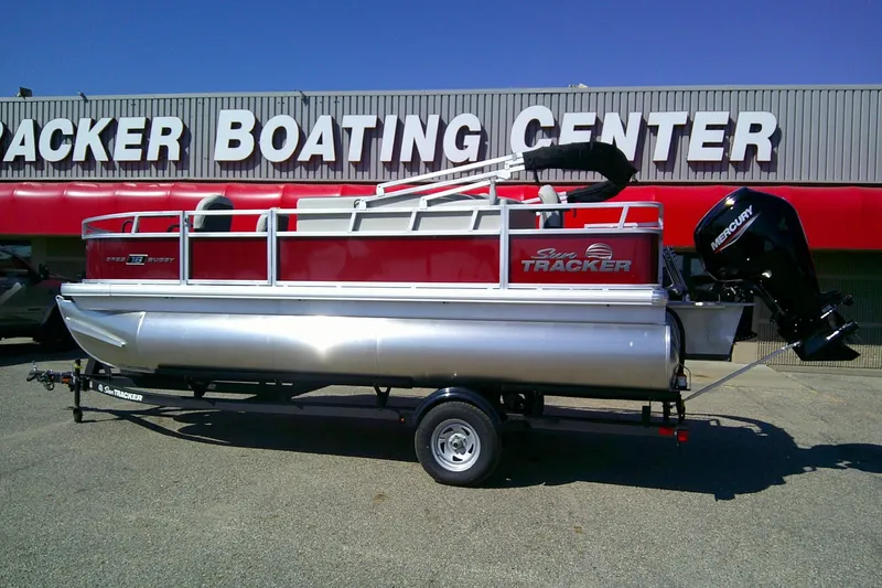 Slide: The Image of 2026 Sun Tracker Bass Buggy 18 DLX pontoon boat at dealership. - 2