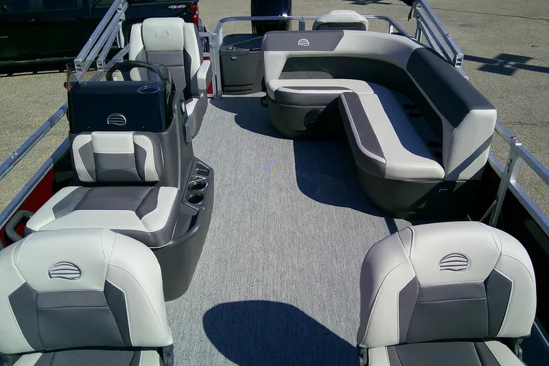 Slide: The Image of 2026 Sun Tracker Bass Buggy 18 DLX pontoon boat interior with gray seating and carpet. - 6
