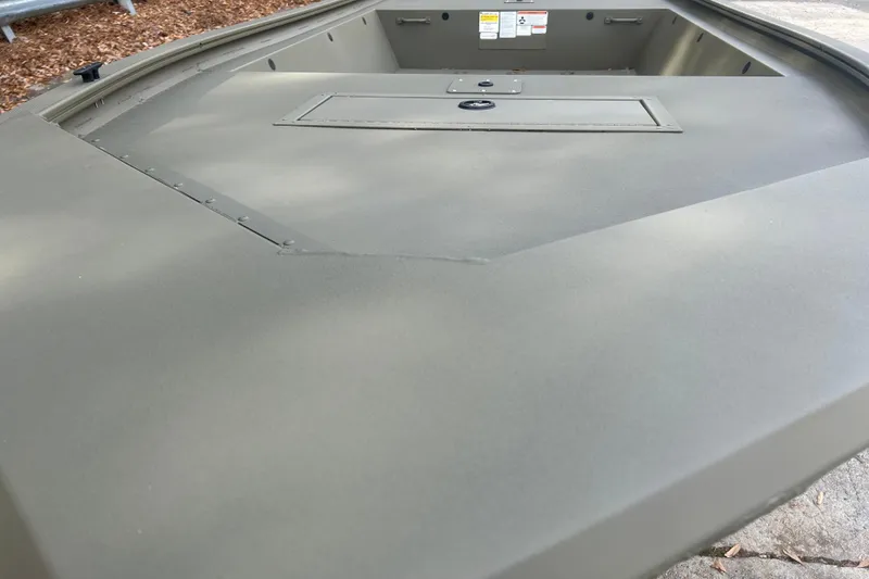 Slide: The Image of 2026 Tracker Grizzly 1648 Utility boat interior with storage compartment. - 2