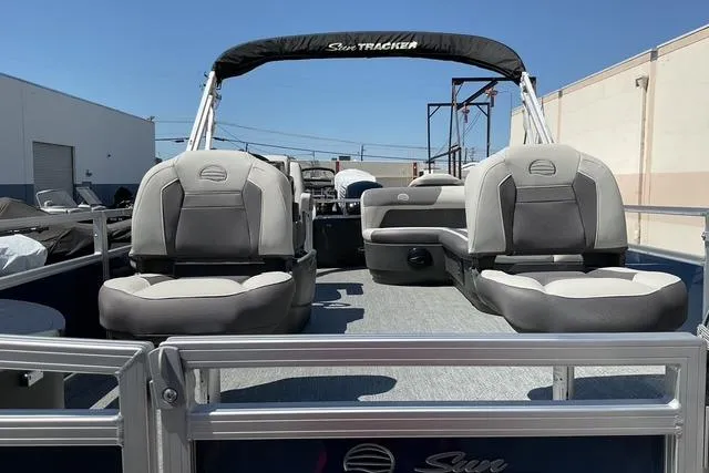Slide: The Image of 2026 Sun Tracker Bass Buggy 18 DLX pontoon boat with comfortable seating and canopy. - 14