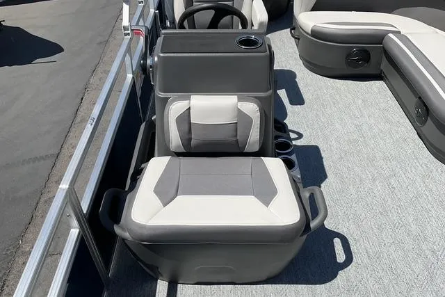 Slide: The Image of 2026 Sun Tracker Bass Buggy 18 DLX boat interior with gray and white seating. - 15