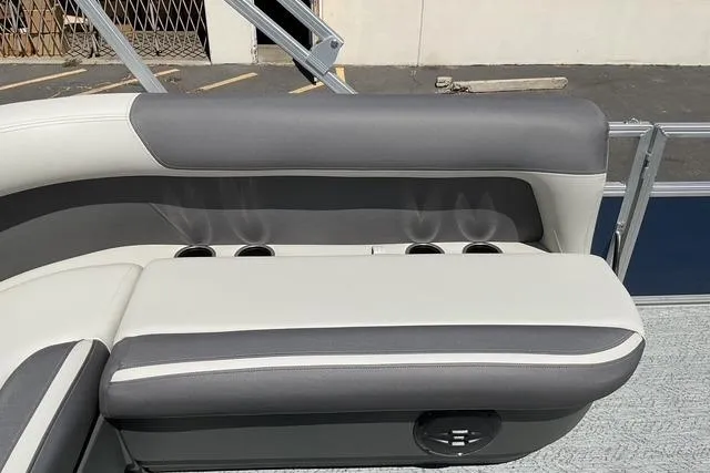 Slide: The Image of 2026 Sun Tracker Bass Buggy 18 DLX boat seat with cup holders, gray and white upholstery. - 17