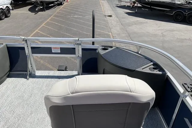 Slide: The Image of 2026 Sun Tracker Bass Buggy 18 DLX pontoon boat interior with seating and storage. - 19