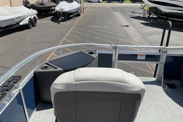 Slide: The Image of 2026 Sun Tracker Bass Buggy 18 DLX pontoon boat interior with seating and storage. - 20