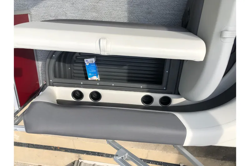 Slide: The Image of 2026 Sun Tracker Bass Buggy 18 DLX boat interior with cup holders and seating. - 17