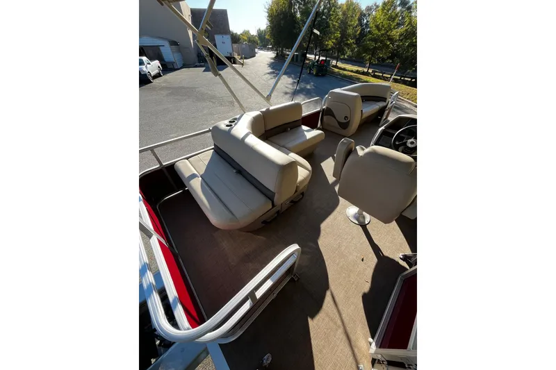 Slide: The Image of 2026 Sun Tracker Bass Buggy 18 DLX interior with beige seating and steering console. - 4