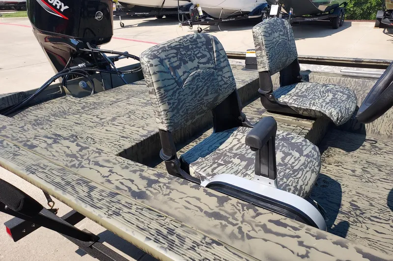 Slide: The Image of 2026 Tracker Grizzly 1754 SC boat with camo seats and Mercury outboard motor. - 2