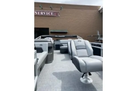 Slide: The Image of 2026 Sun Tracker SportFish 20 DLX boat dashboard with steering wheel and controls. - 13