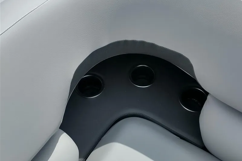 Slide: The Image of 2026 Sun Tracker SportFish 20 DLX boat interior with gray seating and cup holders. - 21