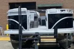 Slide: The Image of 2026 Sun Tracker SportFish 20 DLX pontoon boat, rear view with motor, docked outdoors. - 6